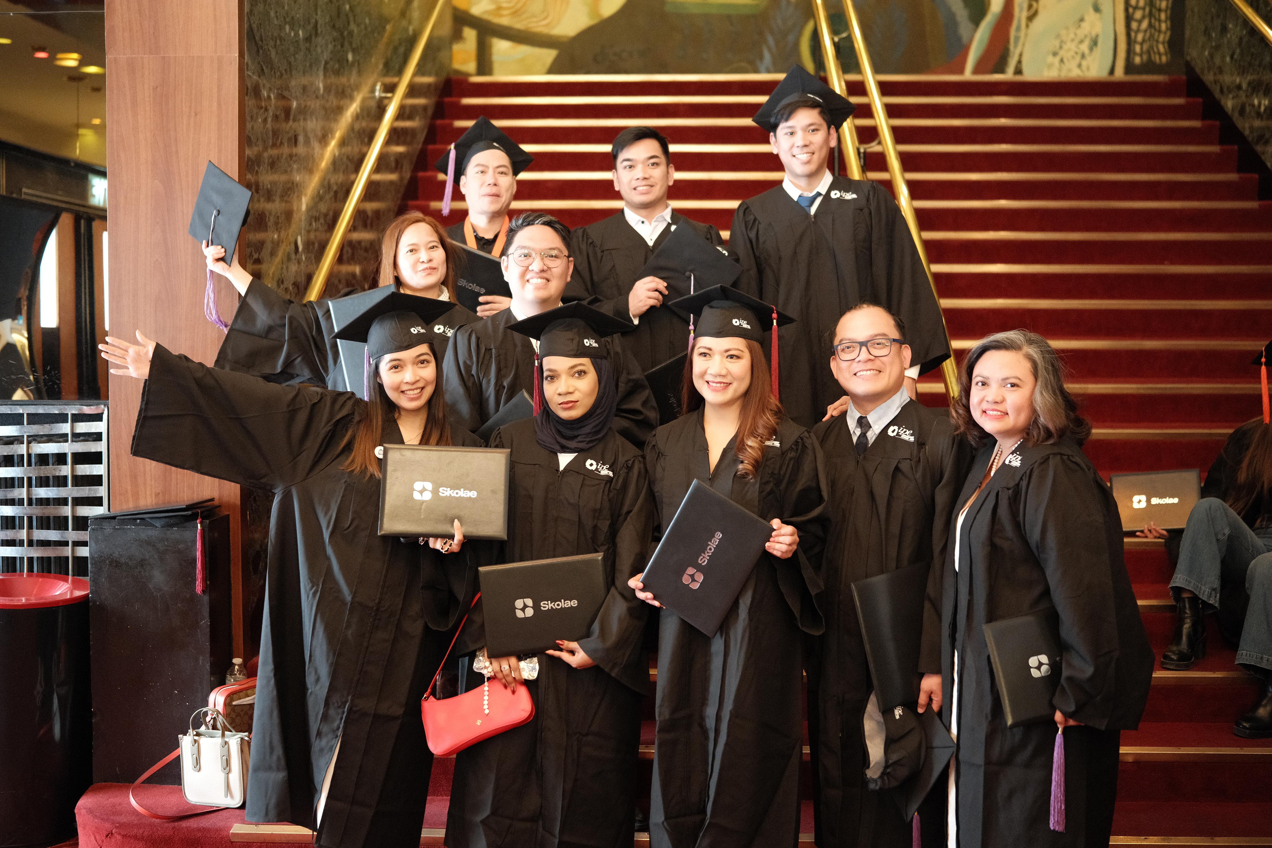 PPA Business School graduates celebrating together on the grand staircase in Paris