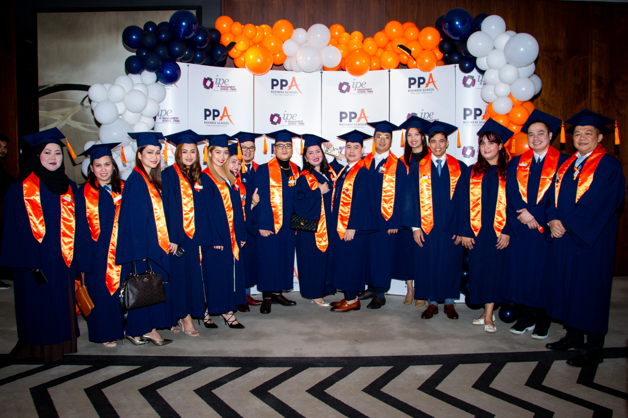 A cohort of PPA Business School graduates posing together at their graduation ceremony